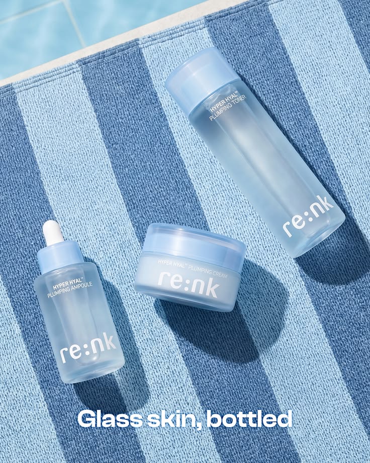 Blue skincare products arranged on a striped towel