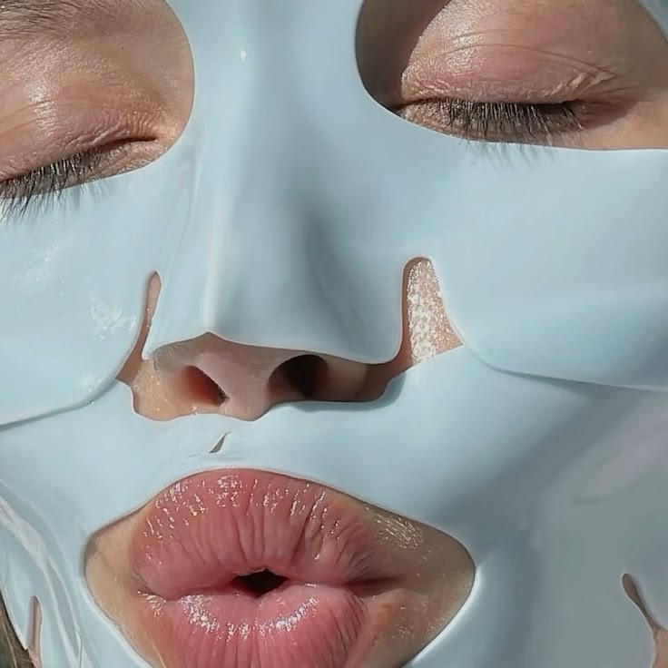 Woman wearing a pale blue hydrogel sheet mask